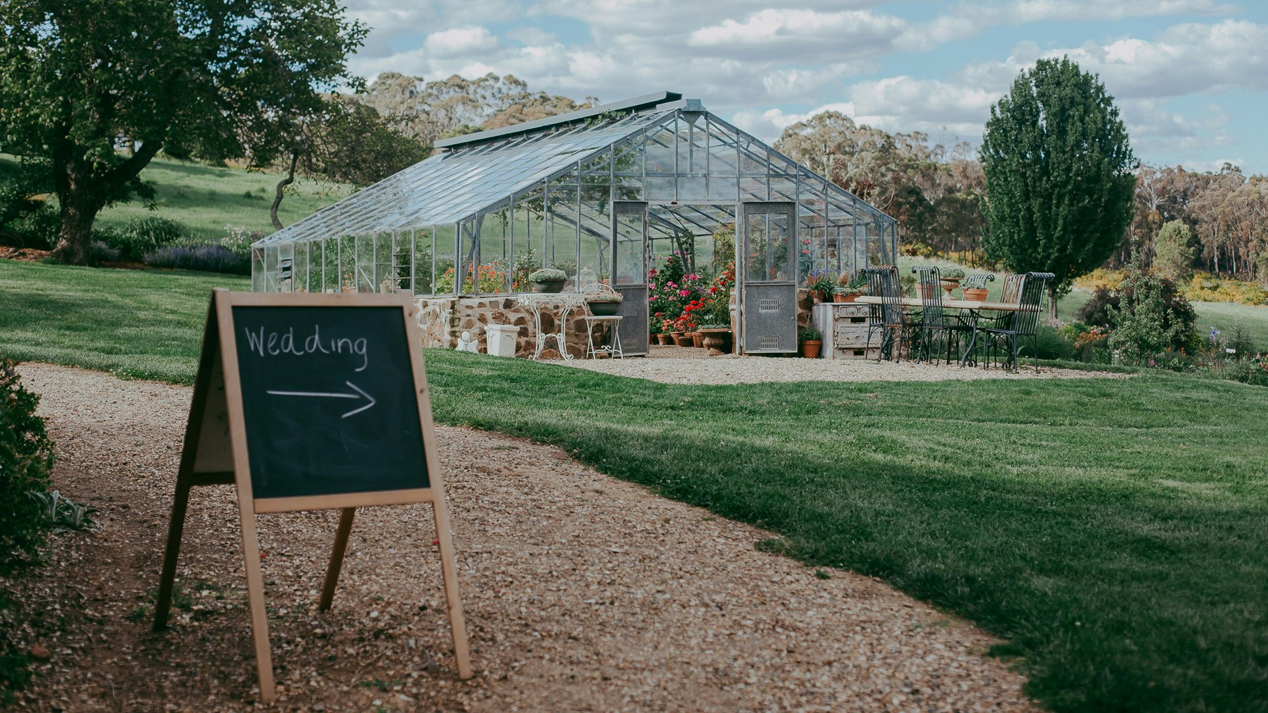 Garden glasshouse setup for a wedding ceremony.